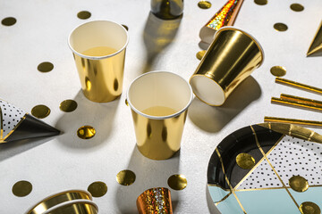 Paper cups of champagne and confetti on white background. New Year Party