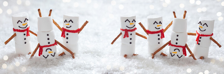 Happy funny marshmallow snowman are having fun in snow. Merry Christmas Winter Panorama. Winter...