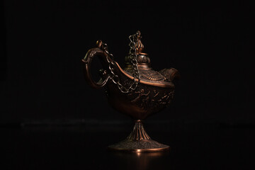 Aladdin's magic lamp isolated on black background