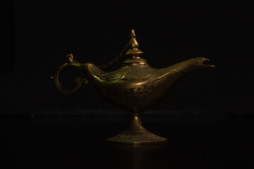Fototapeta na wymiar Aladdin's magic lamp isolated on black background