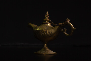 Aladdin's magic lamp isolated on black background