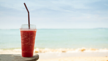 Watermelon Red Smoothie in Glass on Blur Blue Sea and Blue Sky Background,Summer Drink Beverage Sweet Cocktail Snack Tropical,Food for Diet Herb Natural Healthy Juice Fruits Beverage Vegetarian.