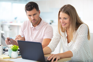 couple with laptop in kitchen