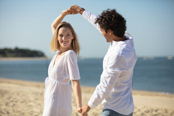 young couple enjoying each other on a beach