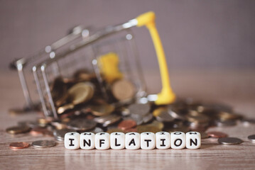 inflation with coin and shopping cart on wooden background, business economy inflation concept of money and finance - Rising grocery prices and surging cost more expensive things