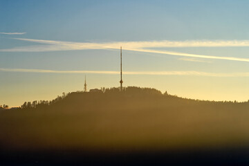 Obraz premium Aerial view over city of Zürich with local mountain Uetliberg in the background and bright sunlight and beautiful autumn evening sun. Photo taken December 6th, 2022, Zurich, Switzerland.
