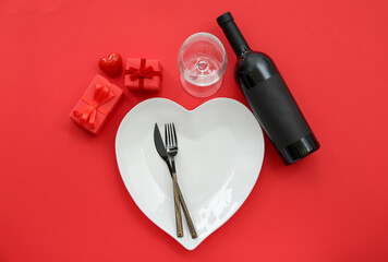 Table setting for Valentine's Day with gifts on red background