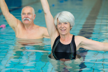 senior couple swimming in the pool