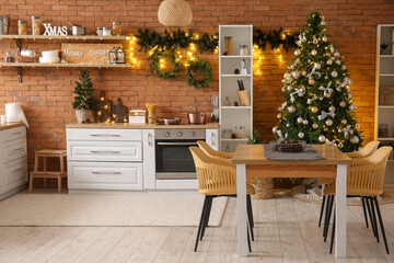 Interior of kitchen with Christmas trees, shelves and dining table