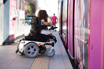 handicapped person getting into a wheelchair on the metro. concept handicapped, social barriers.