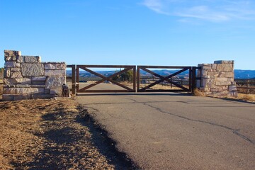 Gate to gated community living space. Beautiful house development in the country background image. With copy Space.