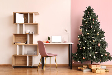 Interior of office with workplace, Christmas tree and presents