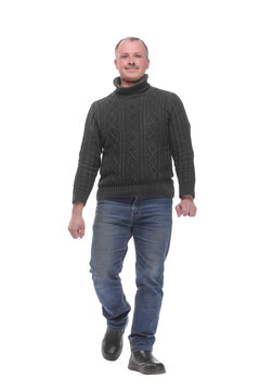 Full length picture of a casual senior man walking towards the camera with a smile on his face