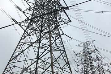 High voltage tower in twilight time in Thailand.Rain falls close.