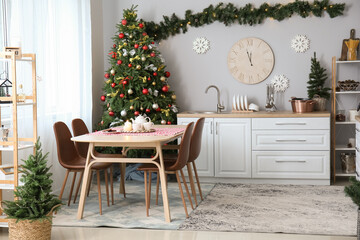 Interior of kitchen with Christmas trees, dining table and big clock