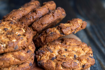 Delicious cookies with pieces of chocolate on the table