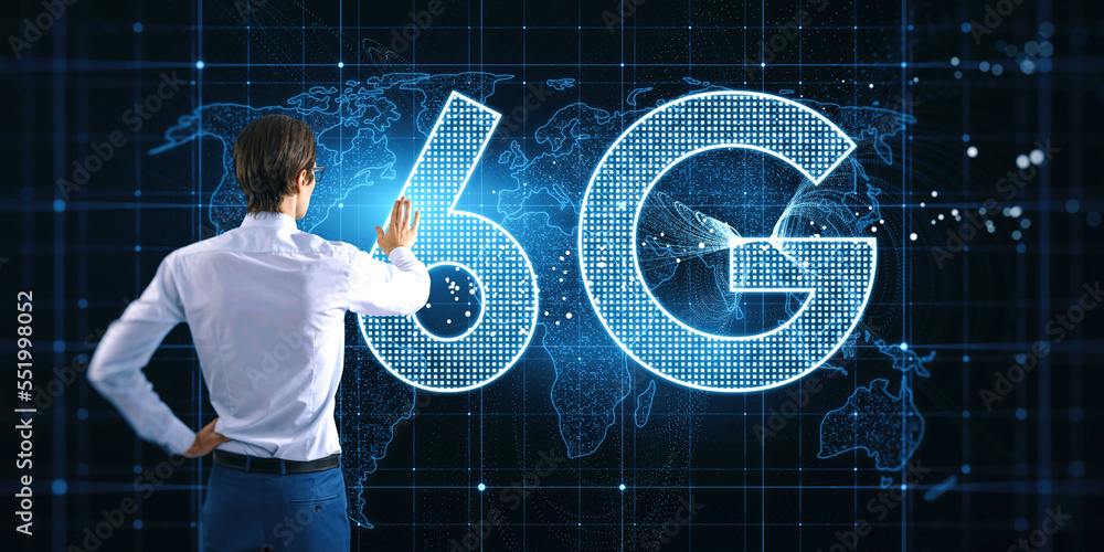 Aufkleber Back view of young businessman using glowing 6G hologram with map on blurry background. Wireless internet and web speed concept.