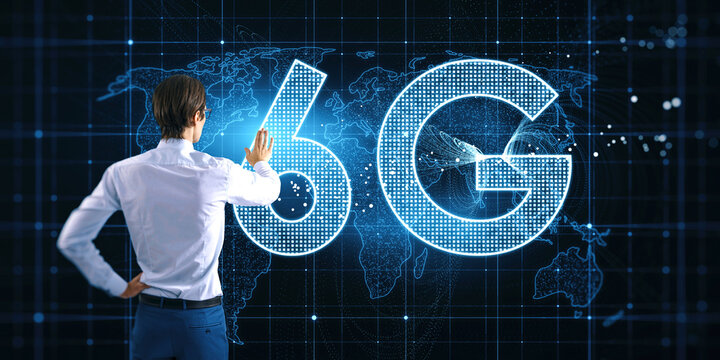 Back view of young businessman using glowing 6G hologram with map on blurry background. Wireless internet and web speed concept. - Powered by Adobe