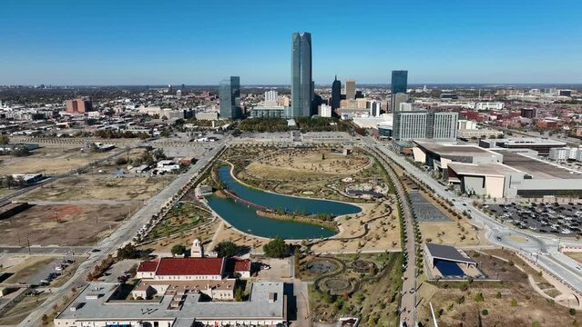 Oklahoma City skyline. Aerial reveal of Scissortail Park and Skydance Bridge. Interstate on sunny day.