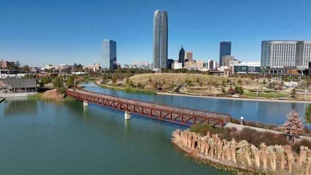 Scissortail Park with bridge over water. Aerial view of OKC skyline. Oklahoma City OK.