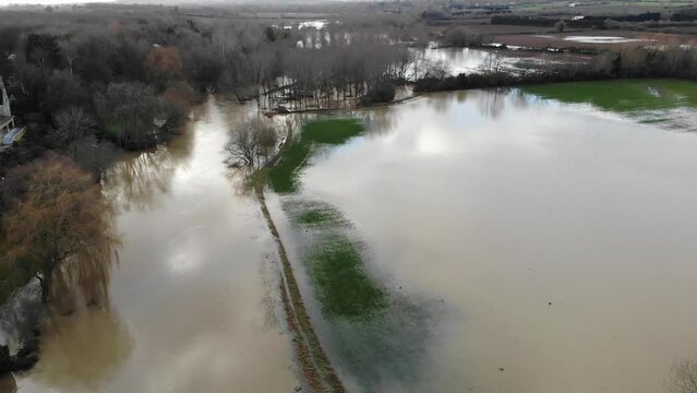 River that has broke its bank and flooded over farmland