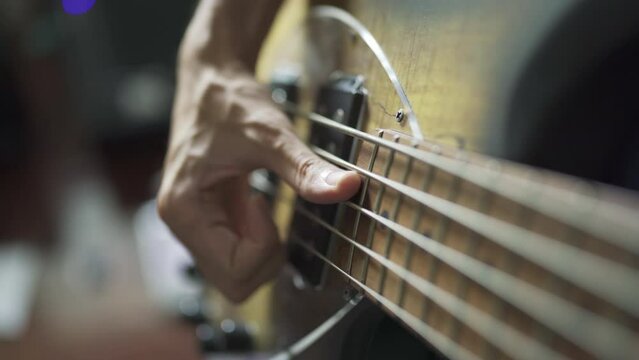 Bassist playing electric bass with slap technique
