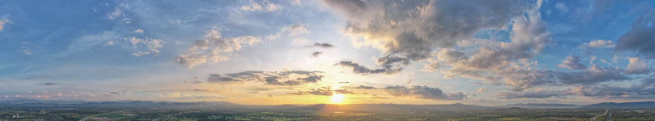 Aerial view of the sunset sky, Panoramic beautiful landscape with  twilight sky, Sun bursting through clouds.