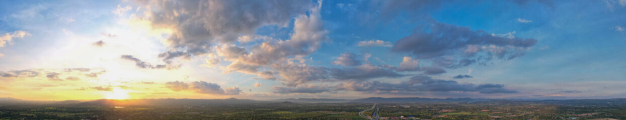 Aerial view of the sunset sky, Panoramic beautiful landscape with  twilight sky, Sun bursting through clouds.