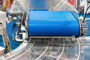 Close up rubber belt and stainless steel wire mesh conveyor of automatic production line of...