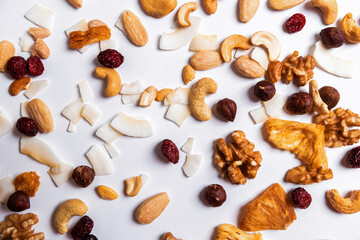 Many mixed nuts and dried fruits pattern isolated on gray background. Top view.