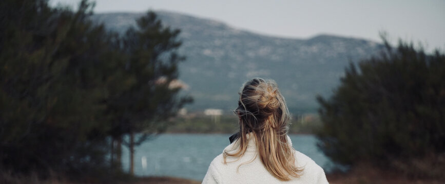 Woman tourist walking towards the lake of Luecate, Languedoc-Roussillon, France. Lake of Salses between the departments of Pyr&eacute;n&eacute;es-Orientales. Natural landscape in the south of France. Surfing spot.