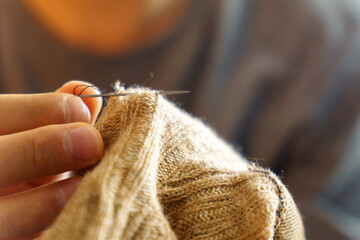 Mending clothes. Sewing supplies and old clothes for repair. Needlework, recycling and thrift. Selective focus