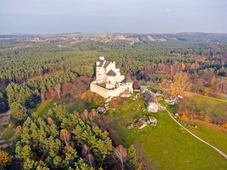 The castle in the forest is seen from a bird's eye view. Photo from a drone. Forest landscape. Fortress, building, defensive walls. Aerial view.