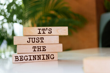 Wooden blocks with words 'It's just the beginning'.