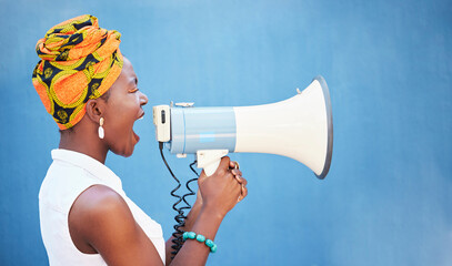 Black woman, megaphone and free space for freedom of speech, justice and equality on blue background for change, motivation and announcement. African female with microphone for protest or broadcast