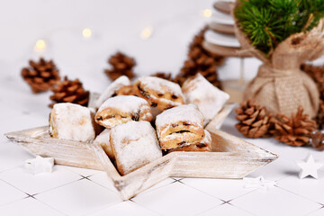 German Stollen cake pieces, a fruit bread with nuts, spices, and dried fruits with powdered sugar traditionally served during Christmas time
