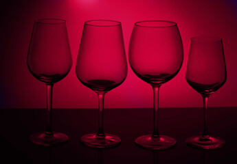 Row of wine glasses on viva magenta background