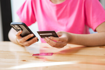 Close up woman shopping online on smartphone using credit card woman paying with device pay bills on the web online banking