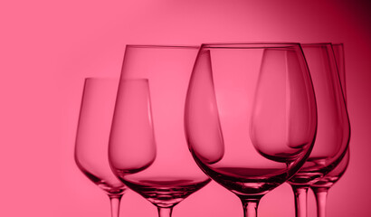 Set of wine glasses on viva magenta background close up with copy space
