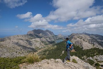Fototapeta premium trekkers watching the Puig Major and Binimorat valley from the forefront of L´Ofre, Three Thousand Route, (Tres Mils), Fornalutx, Majorca, Balearic Islands, Spain
