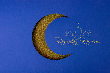 Crescent moon Cut out of paper on a glitter background with empty space for text. Symbol of Eid...