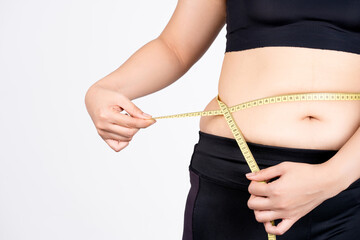Fat woman measuring her stomach isolated on white background. concept of subcutaneous fat breakdown. © PBXStudio