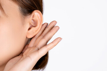 Female with hearing problem on white background. Close up.