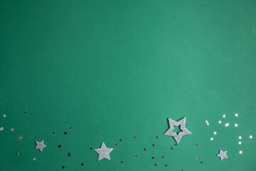 Christmas frame. silver stars on a green background.