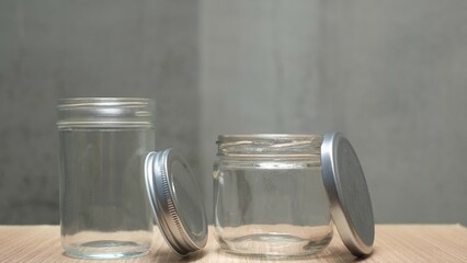 Two opened empty jars on wooden table