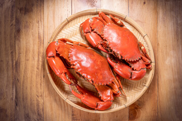 Steamed Red Crab seafood on wooden plate, Boiled Serrated mud crab on wooden plate on wooden background.