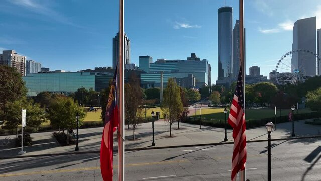 Flag of state of Georgia and USA. Aerial view of Atlanta GA skyline in downtown at Centennial Park.