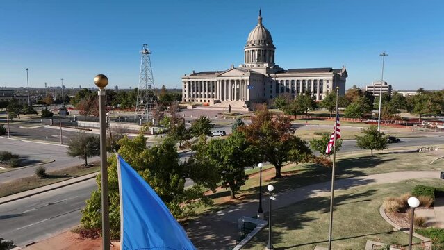Oklahoma flag, oil well and state capitol building. Symbols of OKC. Oklahoma City. USA American flag with OK flag.
