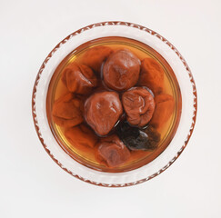 ガラス容器に入れた梅干しと梅酢