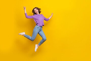 Fototapeta na wymiar Full size portrait of overjoyed nice girl jumping have good mood empty space isolated on yellow color background